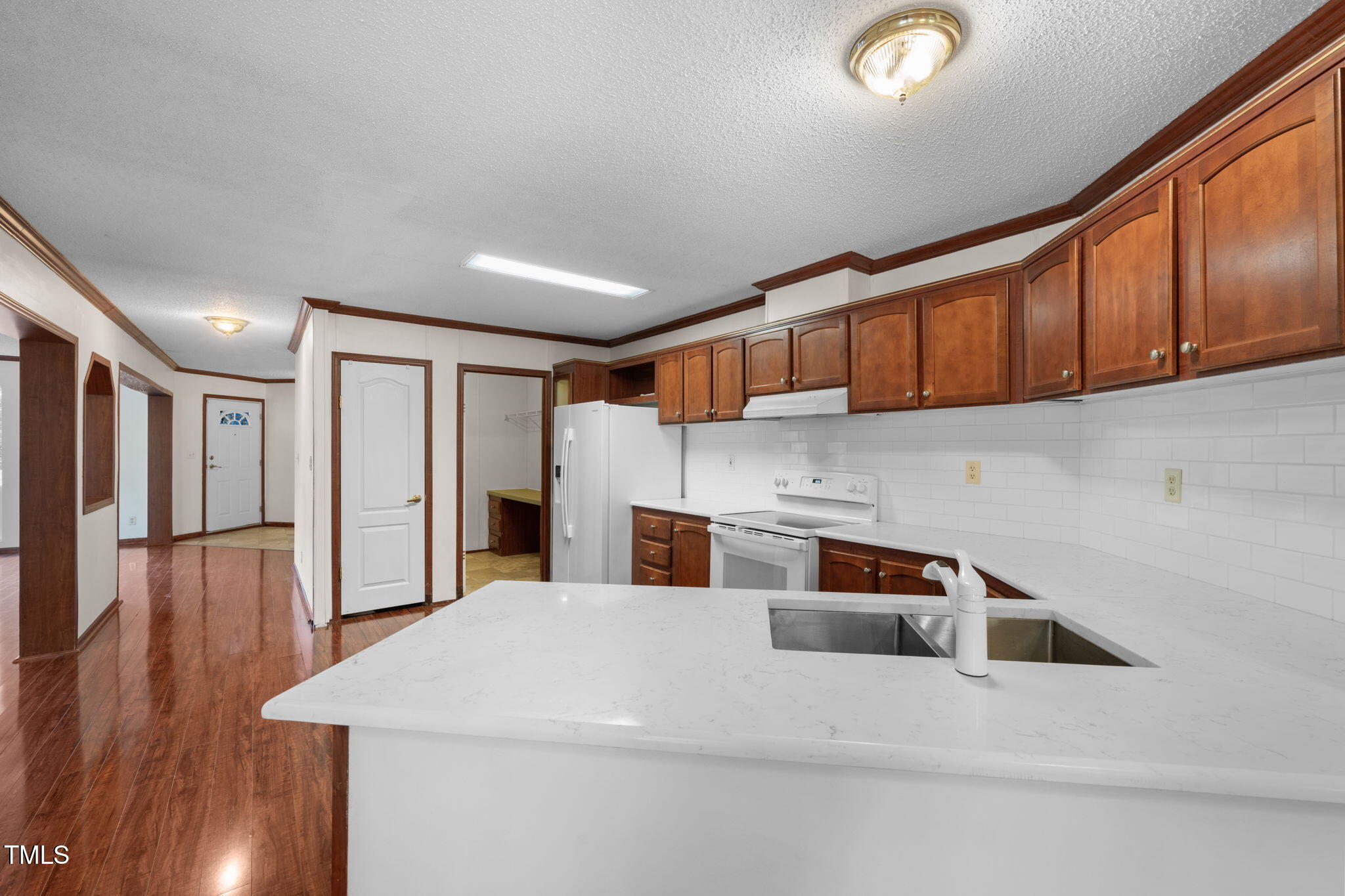 538 Allie Clay Road Roxboro, NC 27573 - Photo 8 of 37 a kitchen with stainless steel appliances kitchen island granite countertop a refrigerator and wooden cabinets