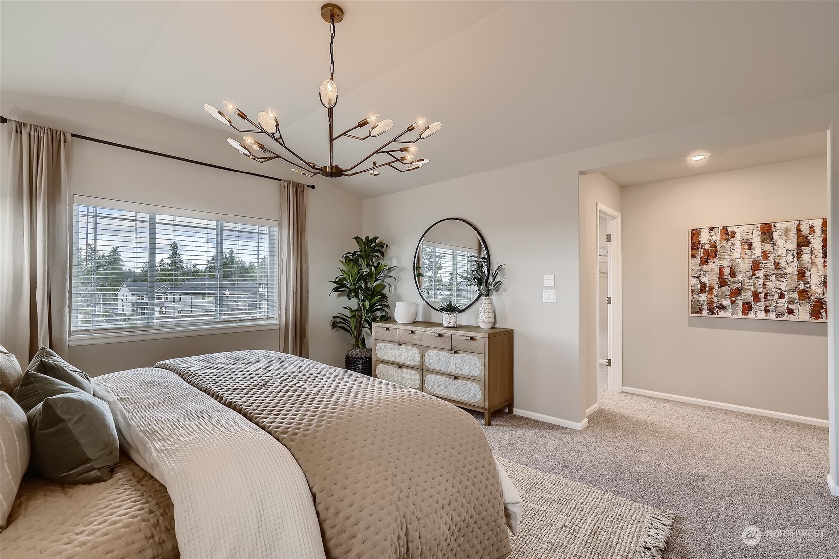 21032 42nd Drive Southeast, Unit 129 Bothell, WA 98021 - Photo 16 of 22 a bedroom with a large bed and a chandelier