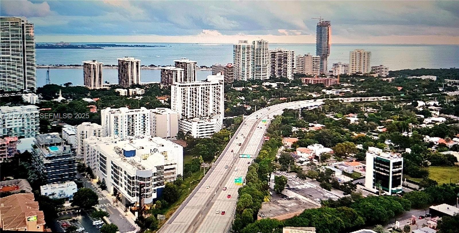 364 Southwest 11th Street Miami, FL 33130 - Photo 13 of 61 a city view from a balcony with chairs and iron gate