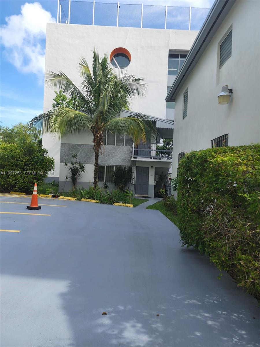 364 Southwest 11th Street Miami, FL 33130 - Photo 15 of 61 a front view of a house with a yard and garage