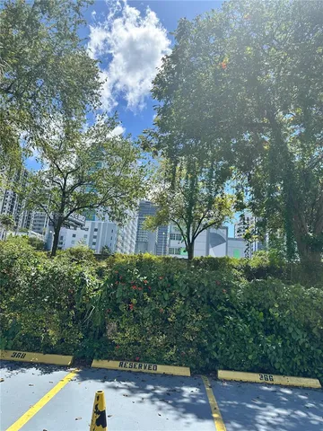 a view of an empty room with window and cabinet