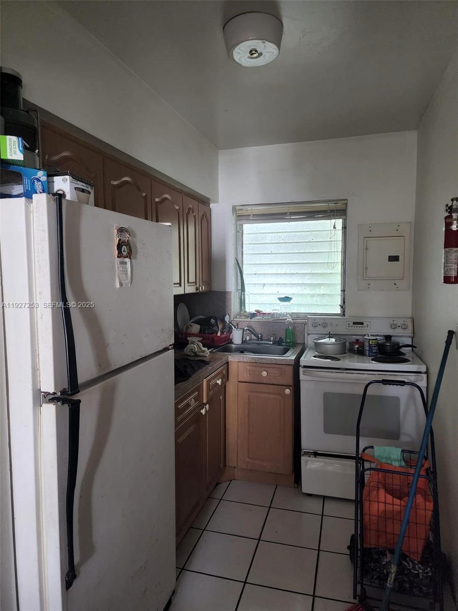 364 Southwest 11th Street Miami, FL 33130 - Photo 28 of 61 a kitchen with a refrigerator and a sink