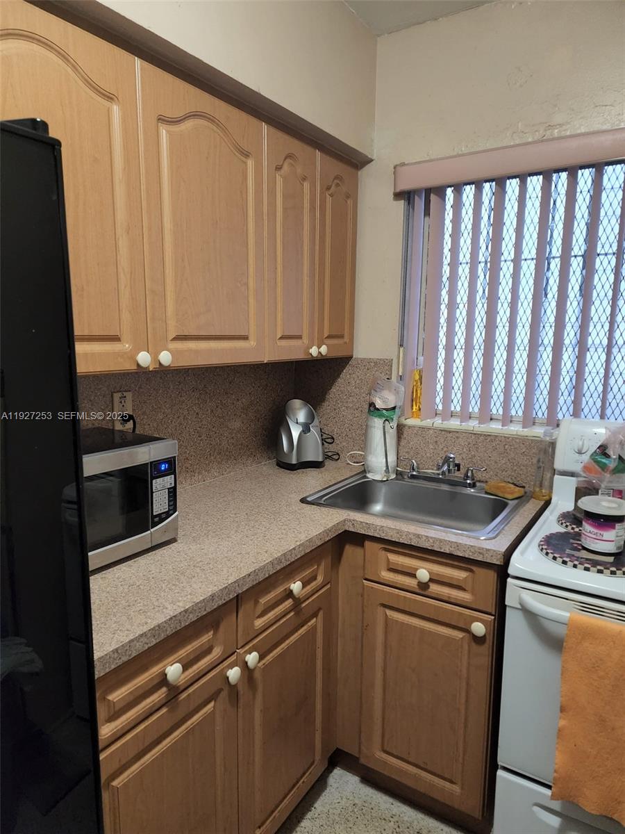 364 Southwest 11th Street Miami, FL 33130 - Photo 30 of 61 a kitchen with stainless steel appliances granite countertop a sink stove and cabinets