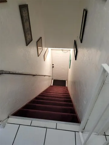 a kitchen with a stove a microwave and cabinets