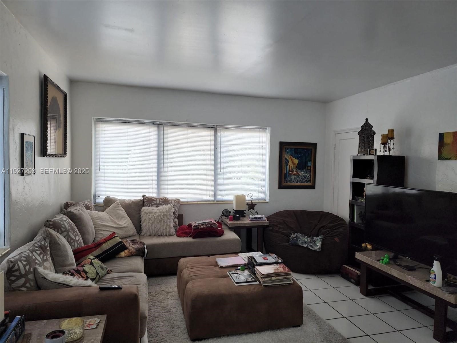 364 Southwest 11th Street Miami, FL 33130 - Photo 39 of 61 a living room with furniture a flat screen tv and a window
