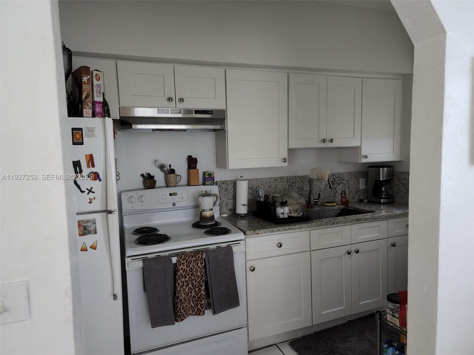 364 Southwest 11th Street Miami, FL 33130 - Photo 42 of 61 a kitchen with stainless steel appliances granite countertop a sink and cabinets
