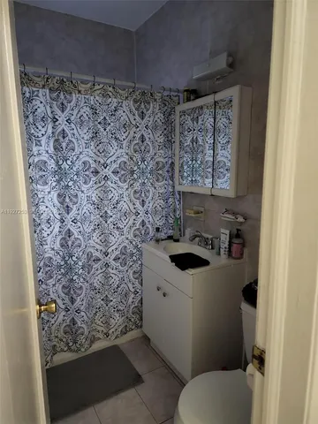 a living room with furniture a dining table and a painting on the wall