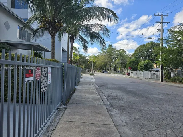 a view of street along with house and trees
