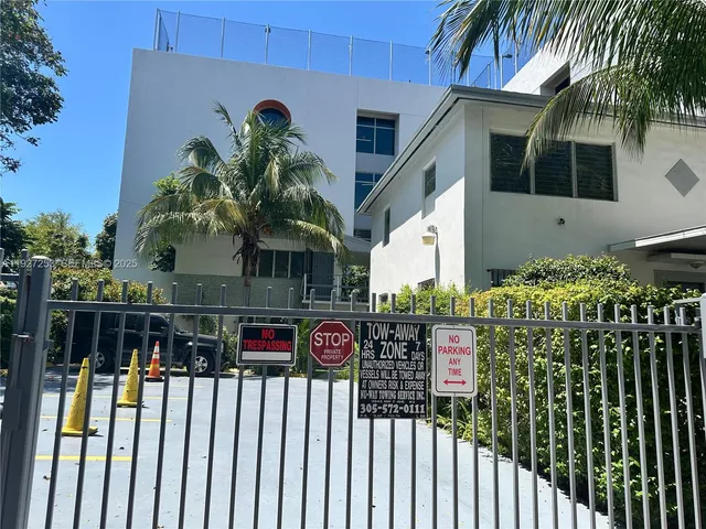 a view of a sign board with flower plants