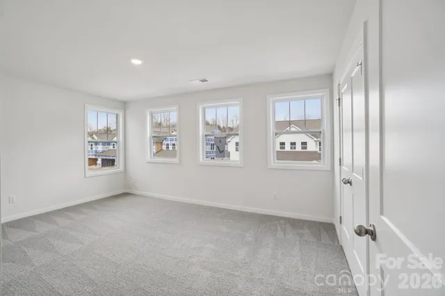 an empty room with windows and closet