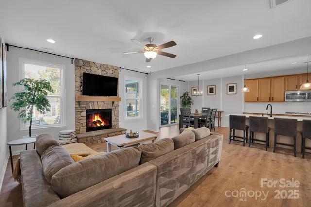 a living room with furniture a fireplace and a flat screen tv