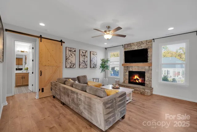 a living room with furniture a fireplace and a flat screen tv