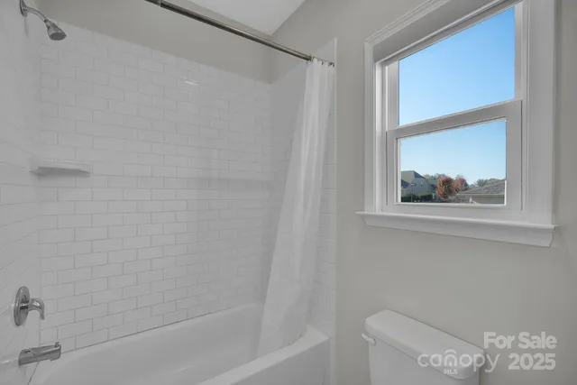 a spacious bedroom with a bed a table and bookshelf
