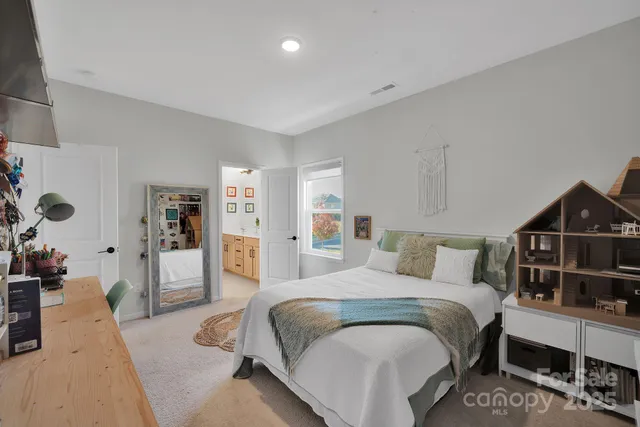 a bedroom with a bed and book shelf