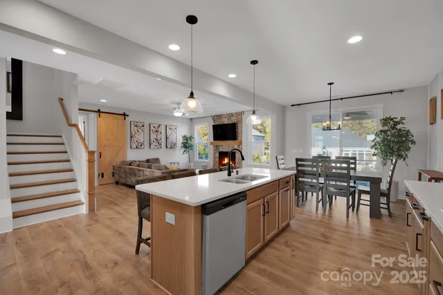 a large kitchen with kitchen island a sink table and chairs
