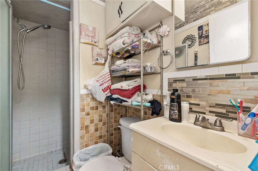 304 Adams Street Taft, CA 93268 - Photo 14 of 28 a utility room with stainless steel appliances kitchen island granite countertop a sink and a refrigerator