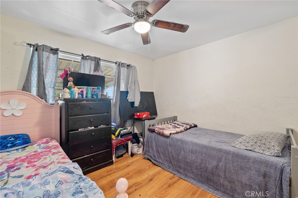 304 Adams Street Taft, CA 93268 - Photo 19 of 28 a bedroom with a bed and a flat tv screen on the dresser