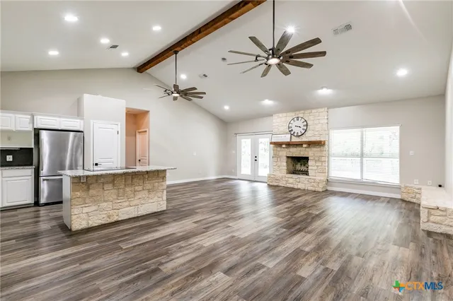 a view of a kitchen with a sink and wooden floor