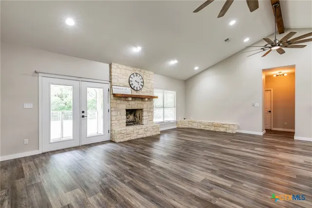a kitchen with a refrigerator sink and cabinets