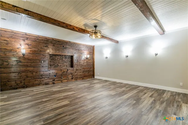 a view of a room with wooden floor and windows