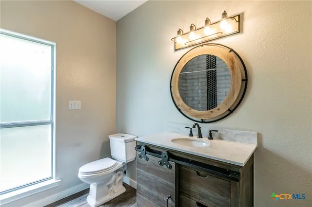 a view of a room with wooden floor and a window
