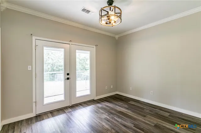 a kitchen with a sink cabinets and wooden floor