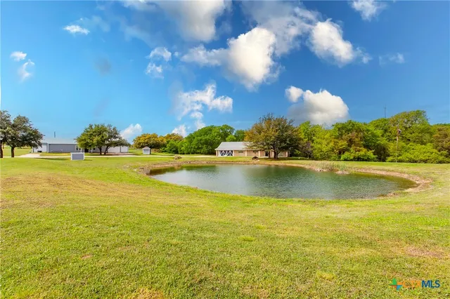 a house view with swimming pool in front of it