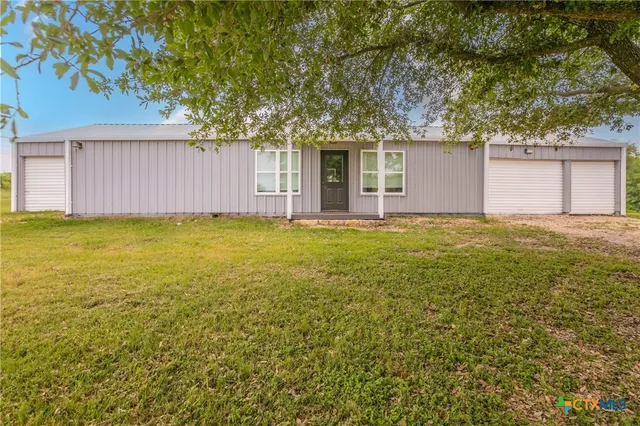 a kitchen with granite countertop a sink stove and refrigerator
