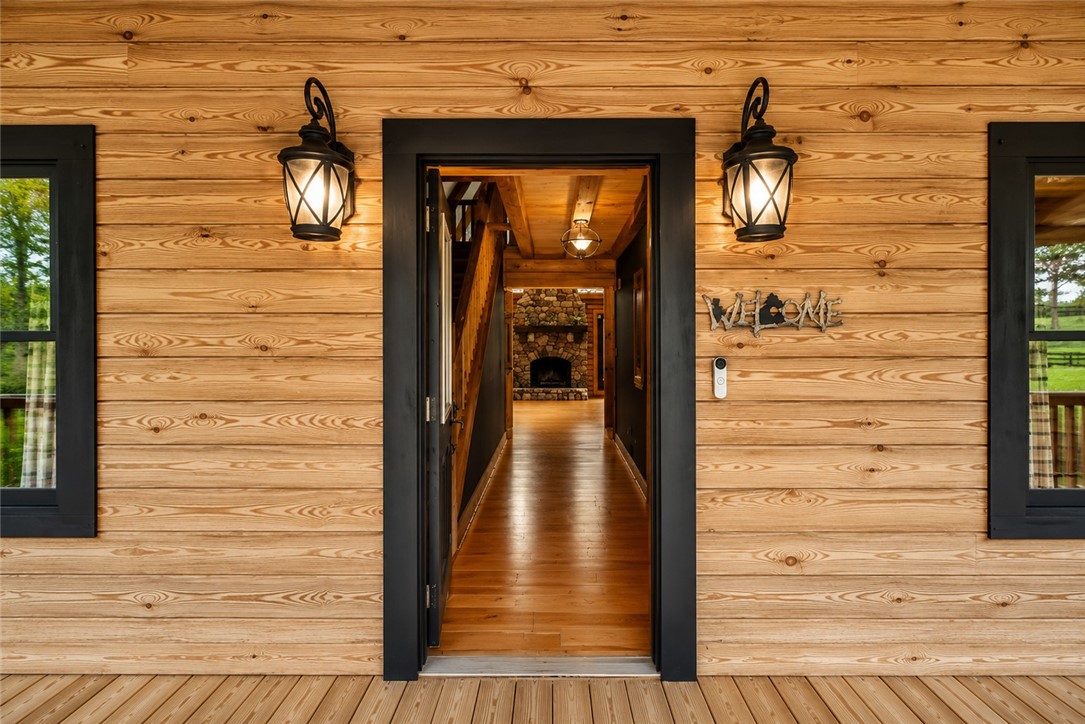 414 Devon Way Anderson, SC 29621 - Photo 4 of 50 A warm welcome beckons through a rustic timber-clad entryway, illuminating the inviting interior beyond.