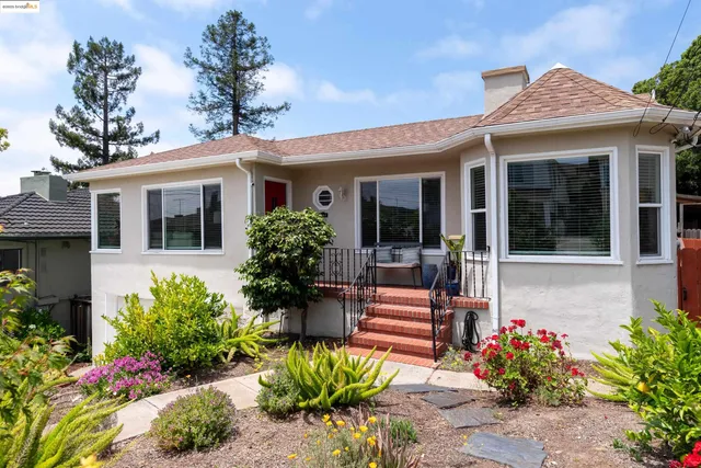 a front view of a house with a flower garden