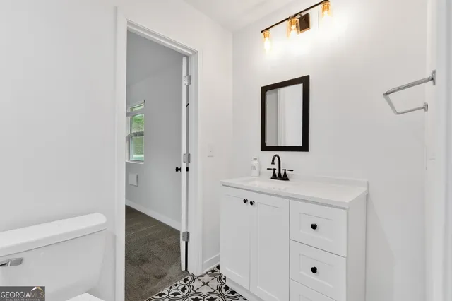 a view of a big room with wooden floor and windows