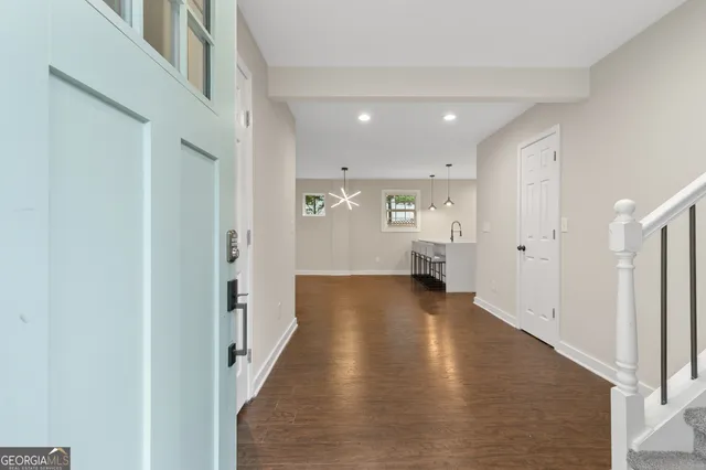 a view of hallway with wooden floor