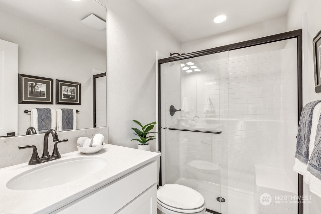 23337 13th (lot 5) Avenue Southeast Bothell, WA 98021 - Photo 11 of 27 a bathroom with a shower sink vanity mirror and toilet