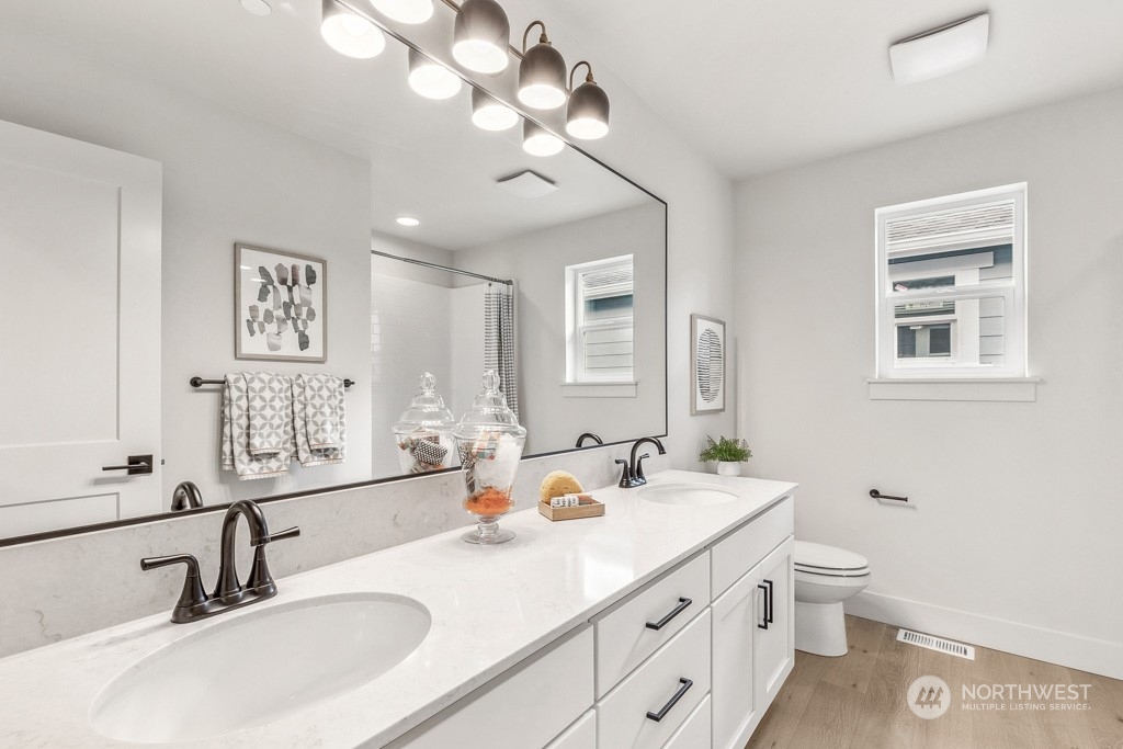 23337 13th (lot 5) Avenue Southeast Bothell, WA 98021 - Photo 17 of 27 a bathroom with a sink double vanity and a mirror