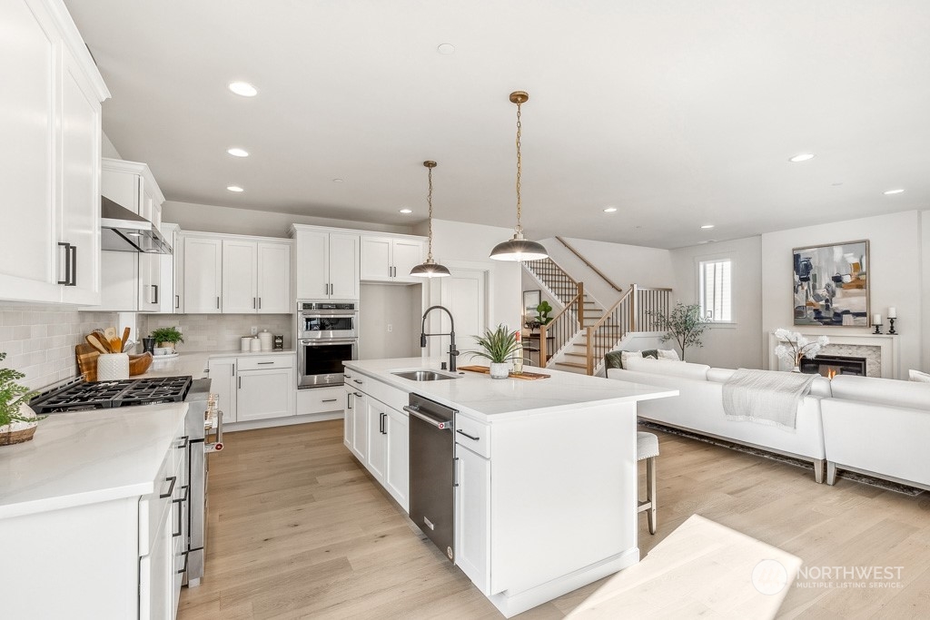 23337 13th (lot 5) Avenue Southeast Bothell, WA 98021 - Photo 2 of 27 a kitchen with white cabinets and white appliances