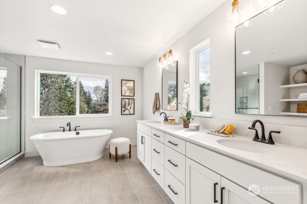 23337 13th (lot 5) Avenue Southeast Bothell, WA 98021 - Photo 21 of 27 a spacious bathroom with double vanity a mirror a bathtub and window