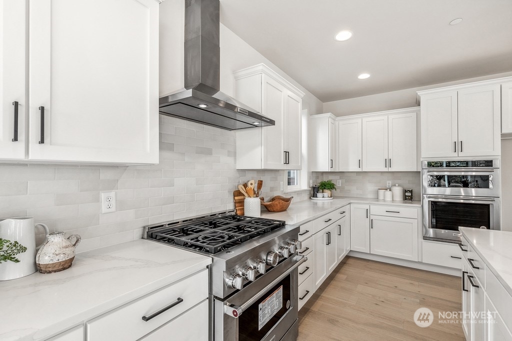 23337 13th (lot 5) Avenue Southeast Bothell, WA 98021 - Photo 6 of 27 a kitchen with stainless steel appliances a stove a sink and cabinets