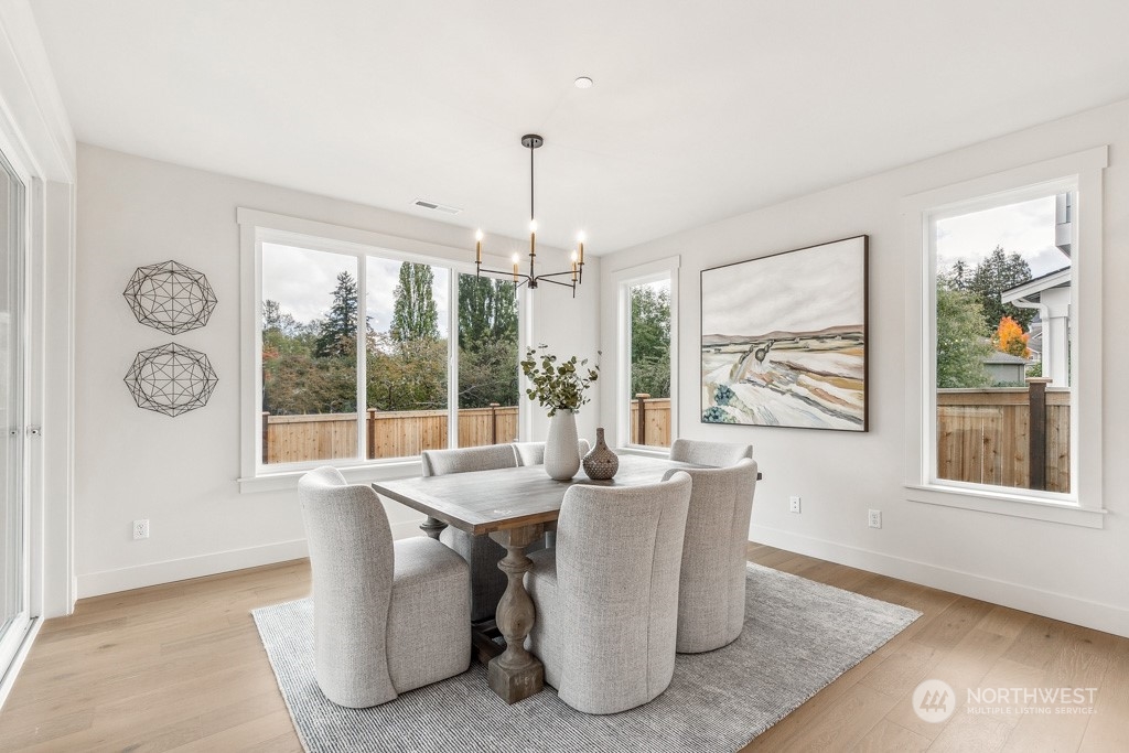 23337 13th (lot 5) Avenue Southeast Bothell, WA 98021 - Photo 8 of 27 a dining room with furniture large windows and wooden floor