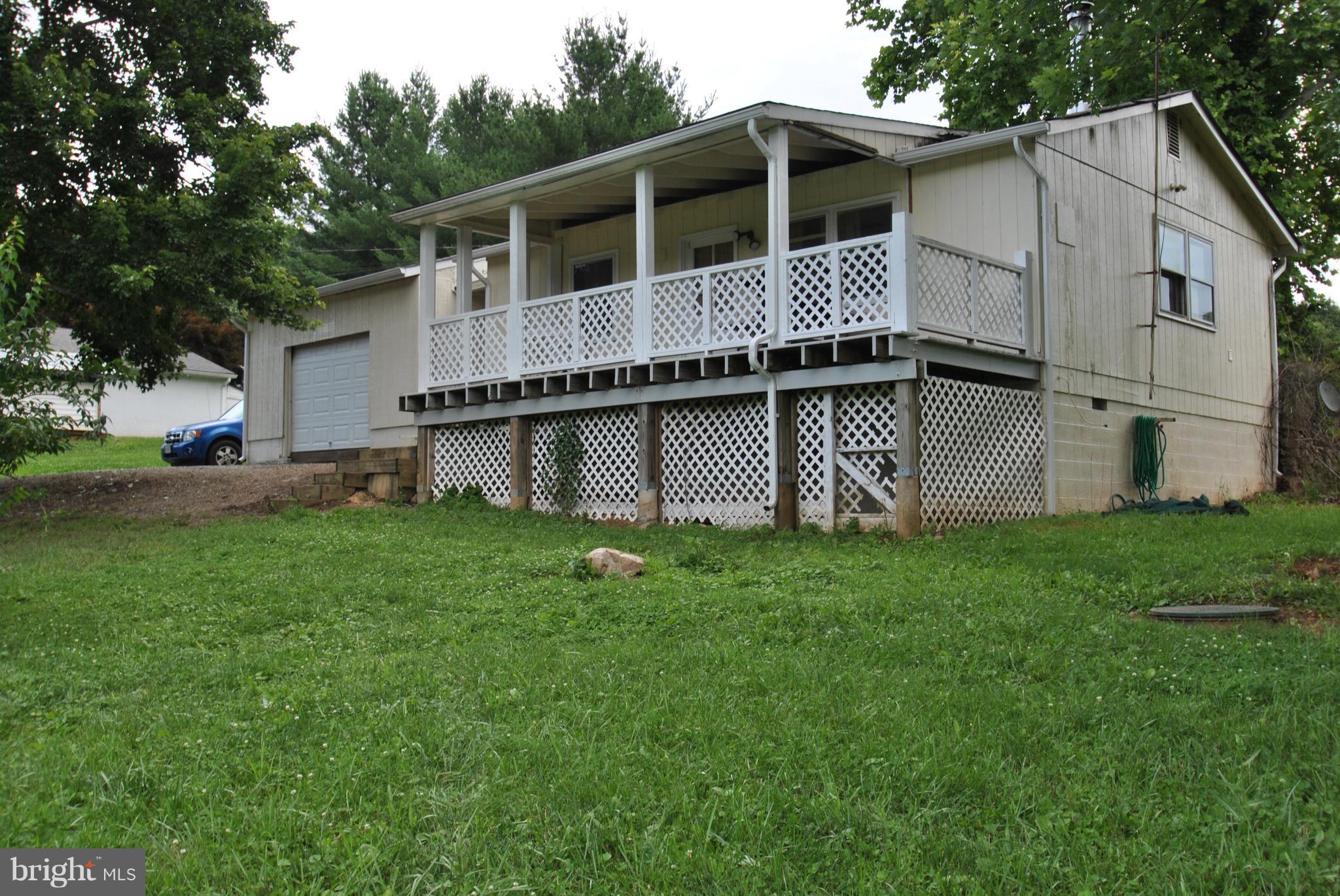 5930 Howellsville Road Front Royal, VA 22630 - Photo 1 of 22 a white house with green field in front of it