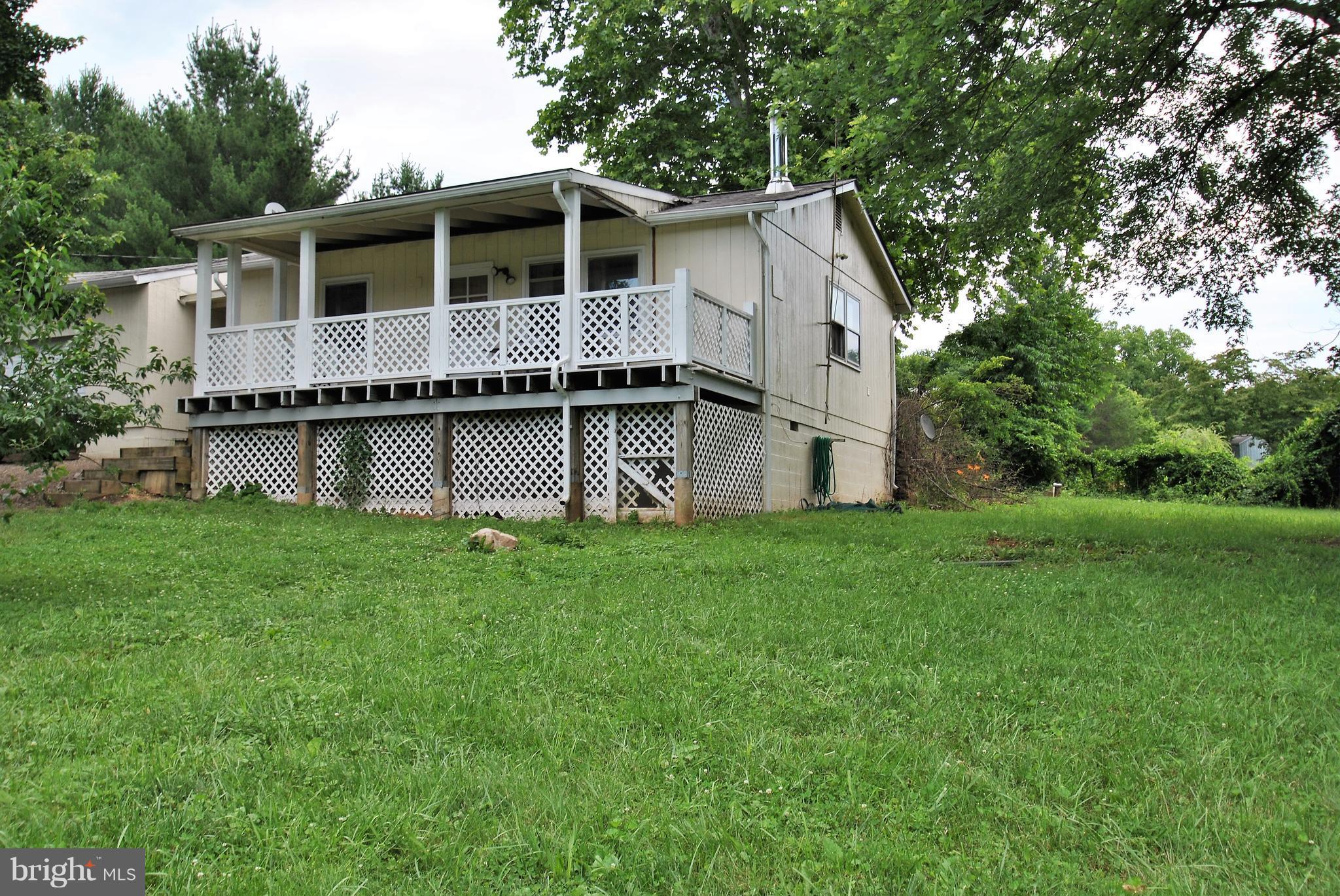 5930 Howellsville Road Front Royal, VA 22630 - Photo 2 of 22 a front view of a house with a yard and garage
