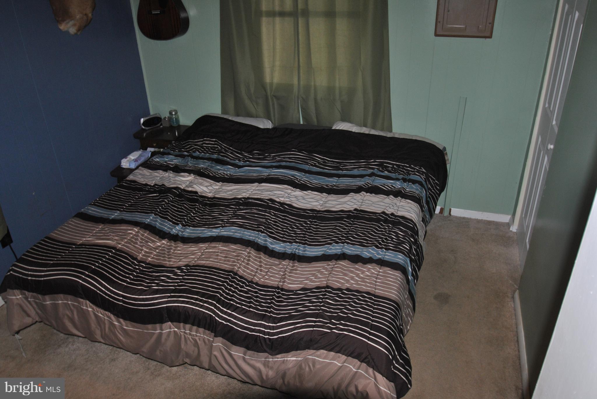 5930 Howellsville Road Front Royal, VA 22630 - Photo 11 of 22 a bed sitting in a bedroom next to a window