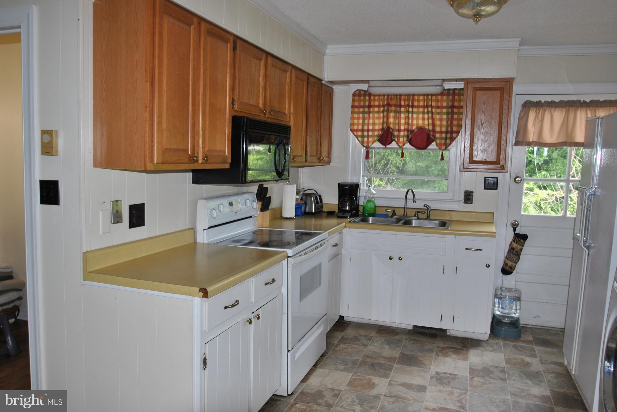 5930 Howellsville Road Front Royal, VA 22630 - Photo 3 of 22 a kitchen with a sink stove and cabinets