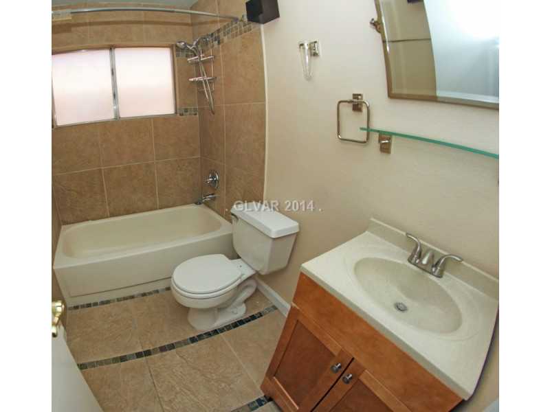 2805 Mirage Road Henderson, NV 89074 - Photo 24 of 34 Bathroom. Hall bath with tile flooring and tile surround