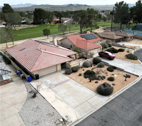 a view of a patio with furniture and garden