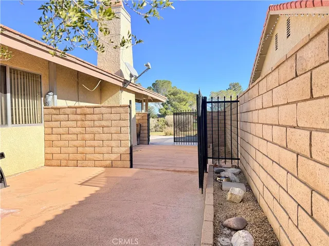 a view of a patio with a table chairs and a yard