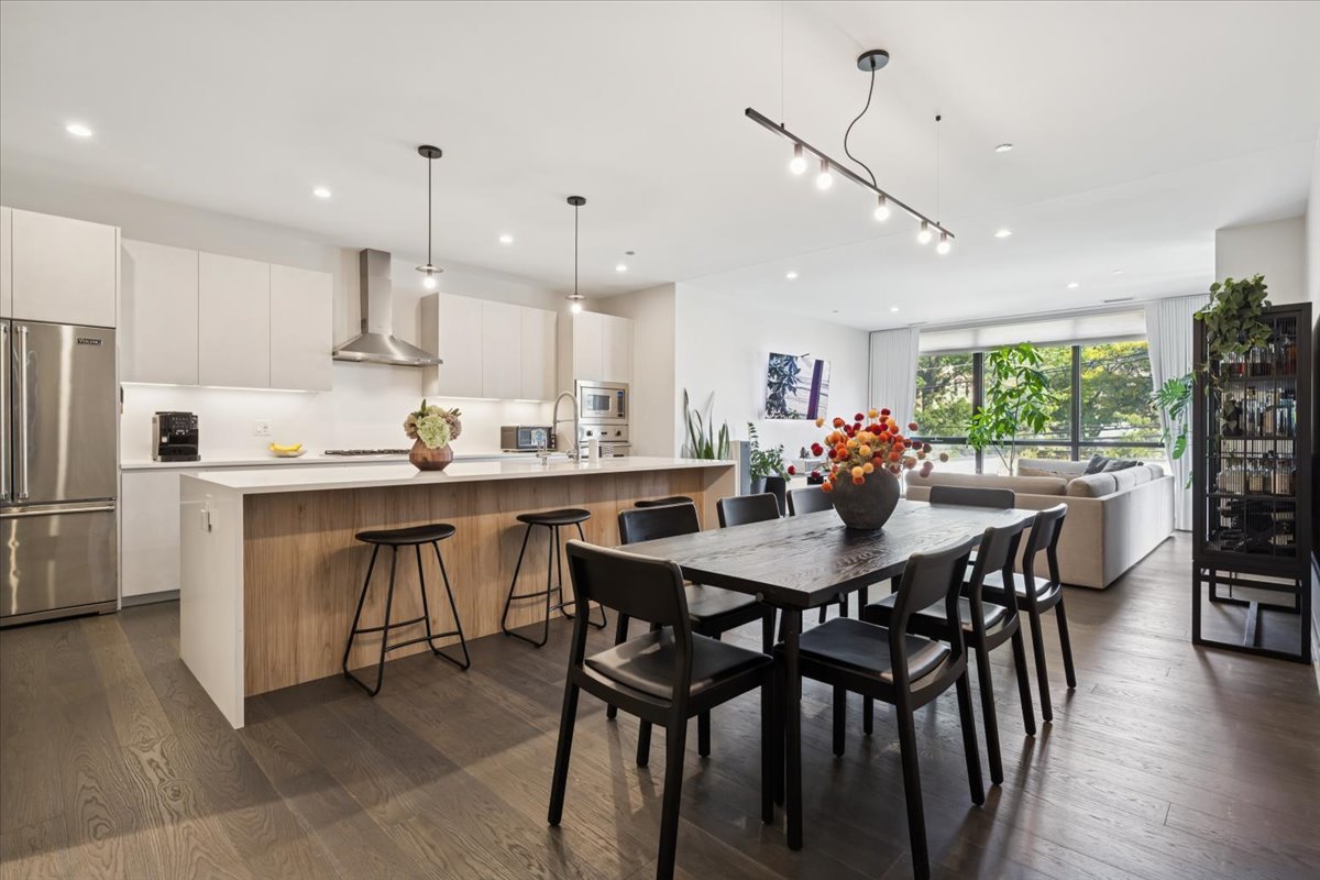 1648 West Division Street, Unit 208 Chicago, IL 60622 - Photo 12 of 48 a kitchen with kitchen island a dining table and chairs
