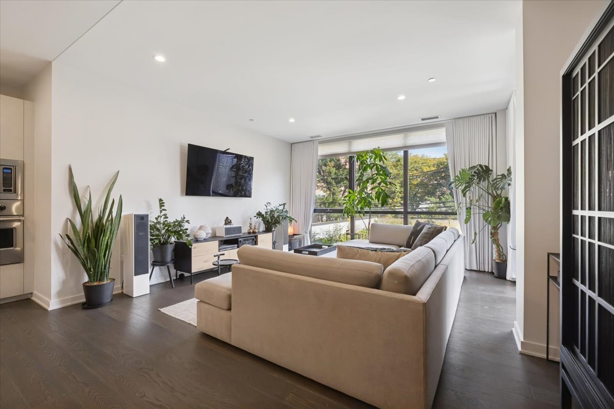 1648 West Division Street, Unit 208 Chicago, IL 60622 - Photo 13 of 48 a living room with furniture a large window and a flat screen tv