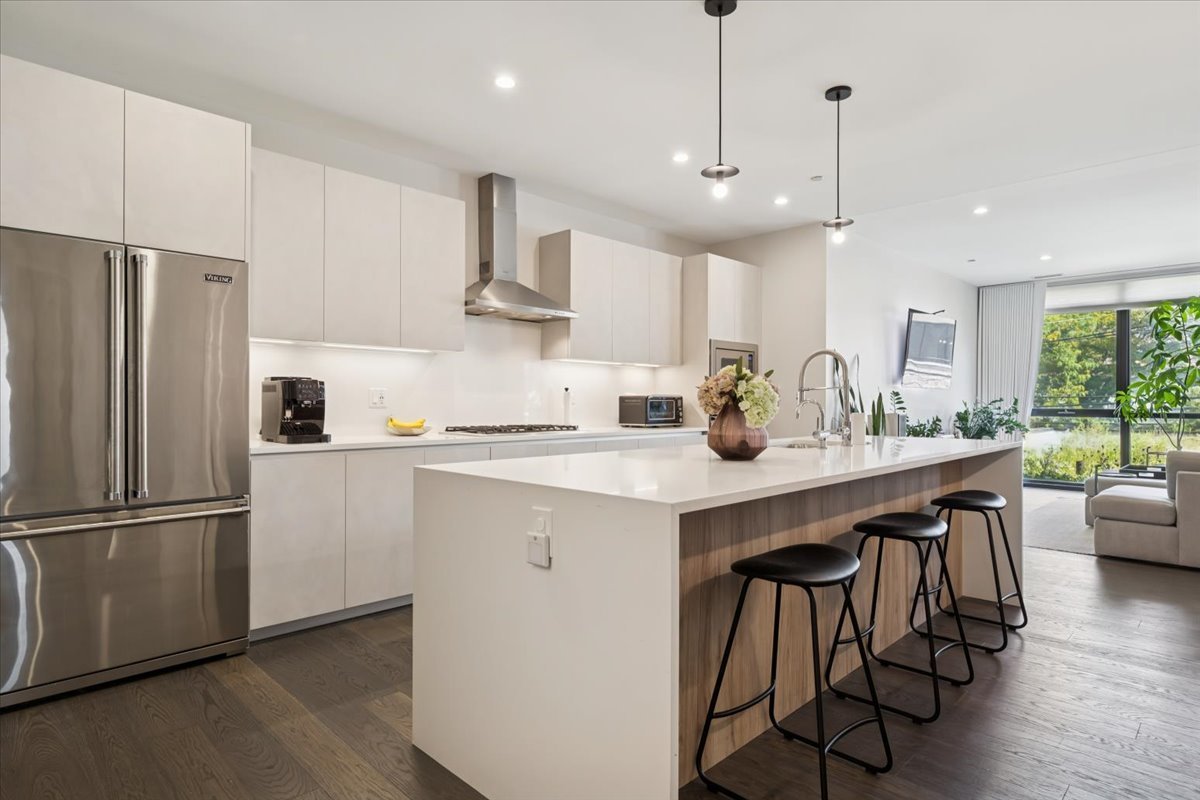 1648 West Division Street, Unit 208 Chicago, IL 60622 - Photo 2 of 48 a kitchen with stainless steel appliances granite countertop a sink a stove a refrigerator and island with wooden floor