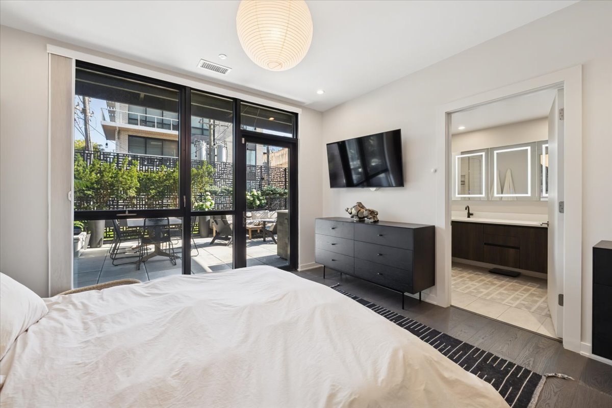 1648 West Division Street, Unit 208 Chicago, IL 60622 - Photo 28 of 48 a bedroom with a bed and a flat screen tv