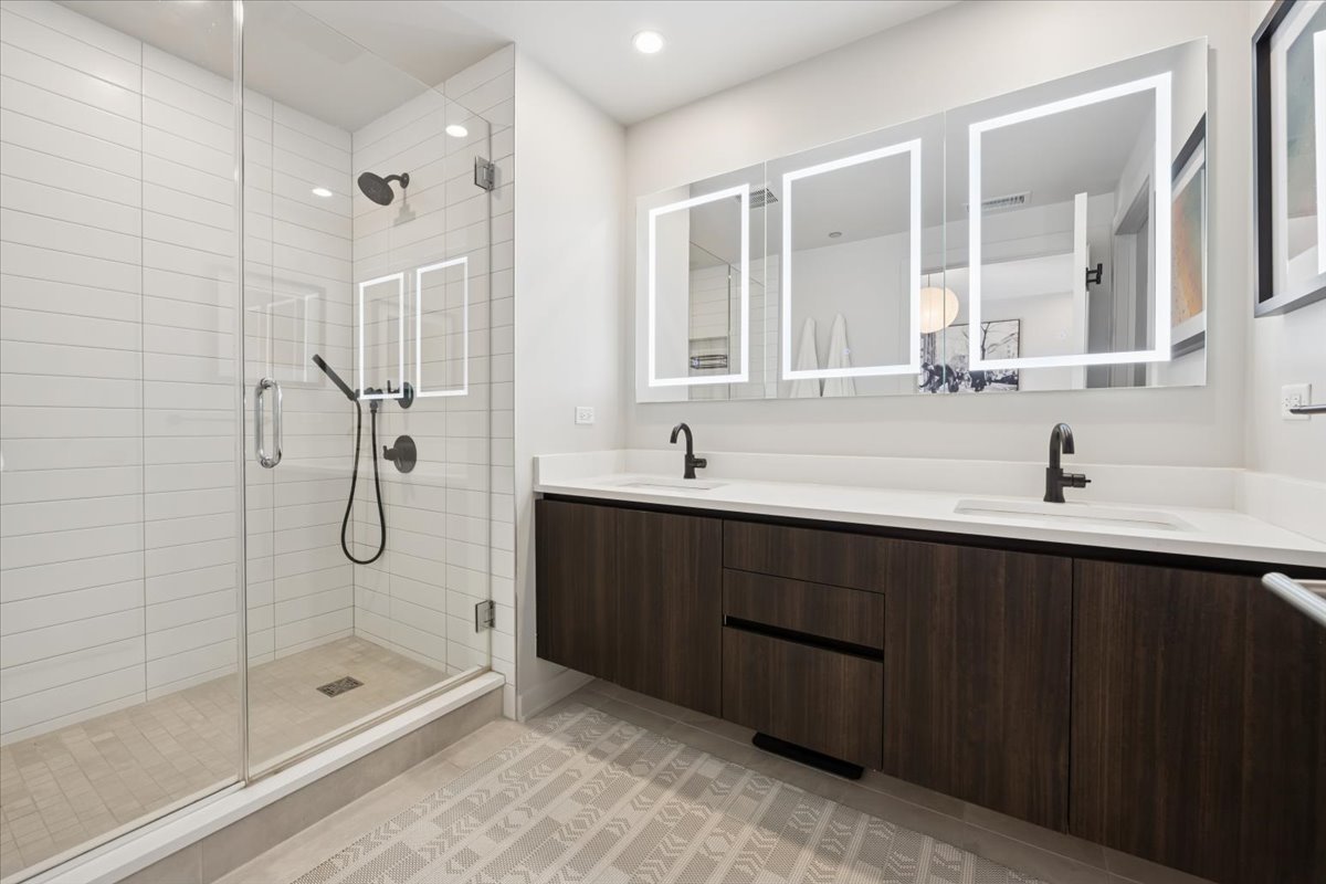 1648 West Division Street, Unit 208 Chicago, IL 60622 - Photo 29 of 48 a bathroom with a shower sink and mirror